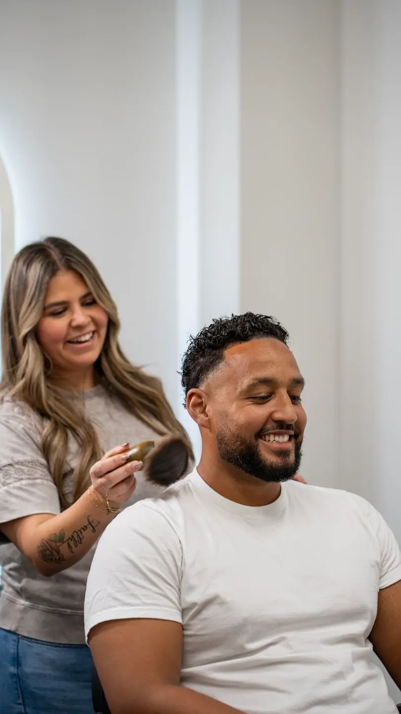 Addy Arechiga, licensed barber and stylist, finishing a client's haircut in her private studio